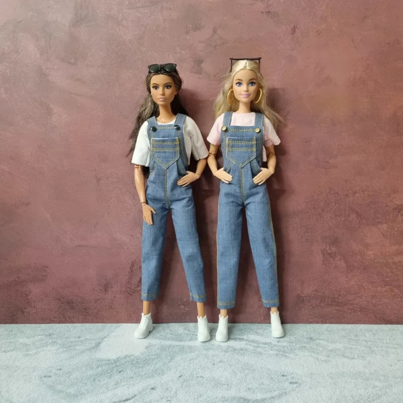 Shop blue denim overalls/dungarees for Barbie and 11.5-inch fashion dolls, shown styled on two dolls.