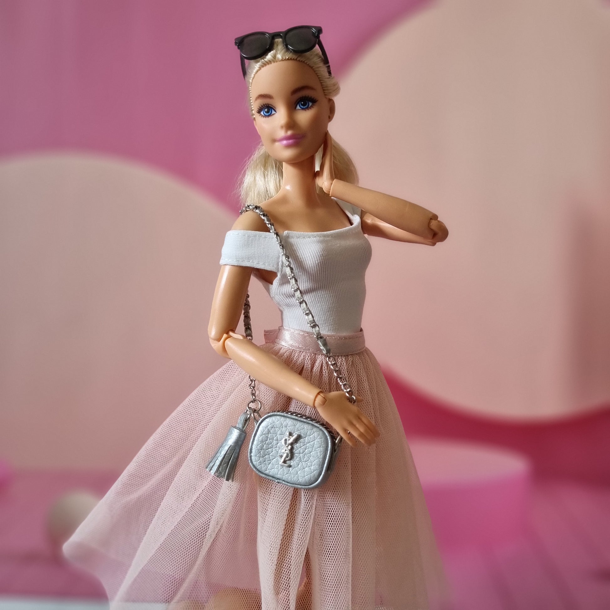 Barbie with white top , skirt and hand bag