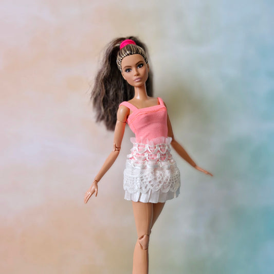 Barbie doll wearing handmade pink leotard and white lace ballet practice skirt front view