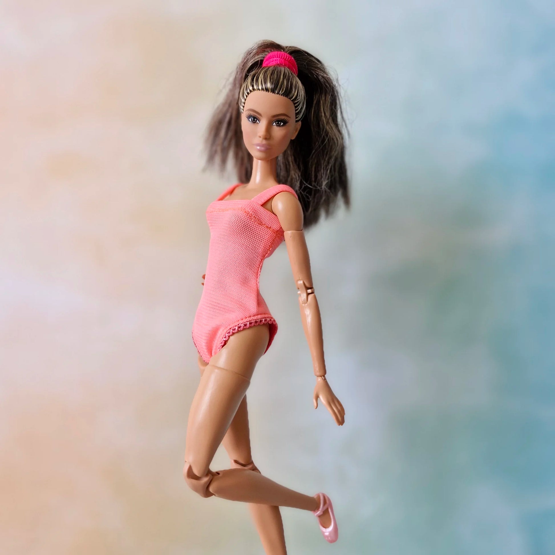 Barbie doll wearing handmade pink ballet leotard bodysuit posing side view