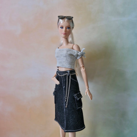 Blonde Barbie doll wearing grey crop top and black denim cargo midi skirt with chain detail