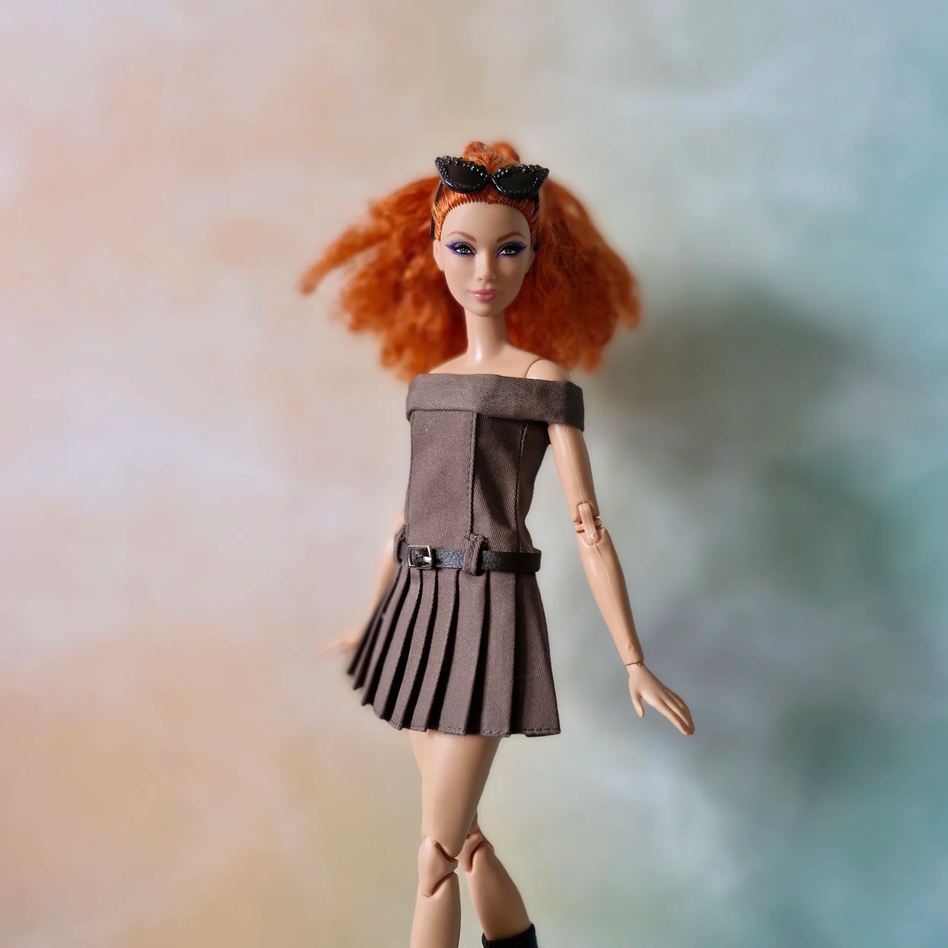 Redhead Barbie doll models brown off-shoulder pleated dress with belt and black boots