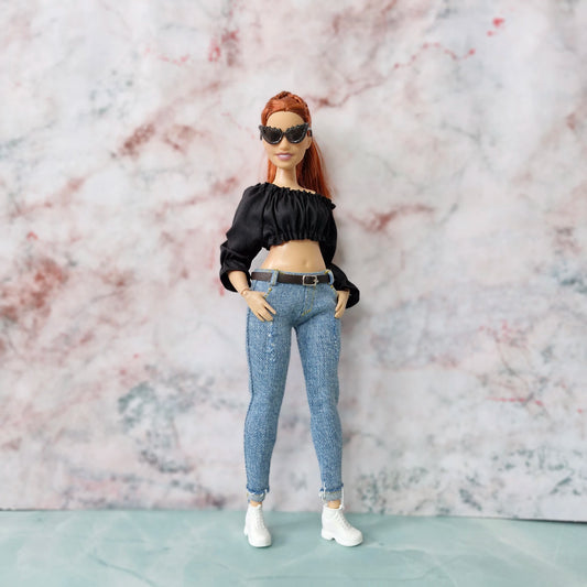 Red-haired Curvy Barbie doll wearing black off-shoulder crop top, skinny jeans, white sneakers, and sunglasses.