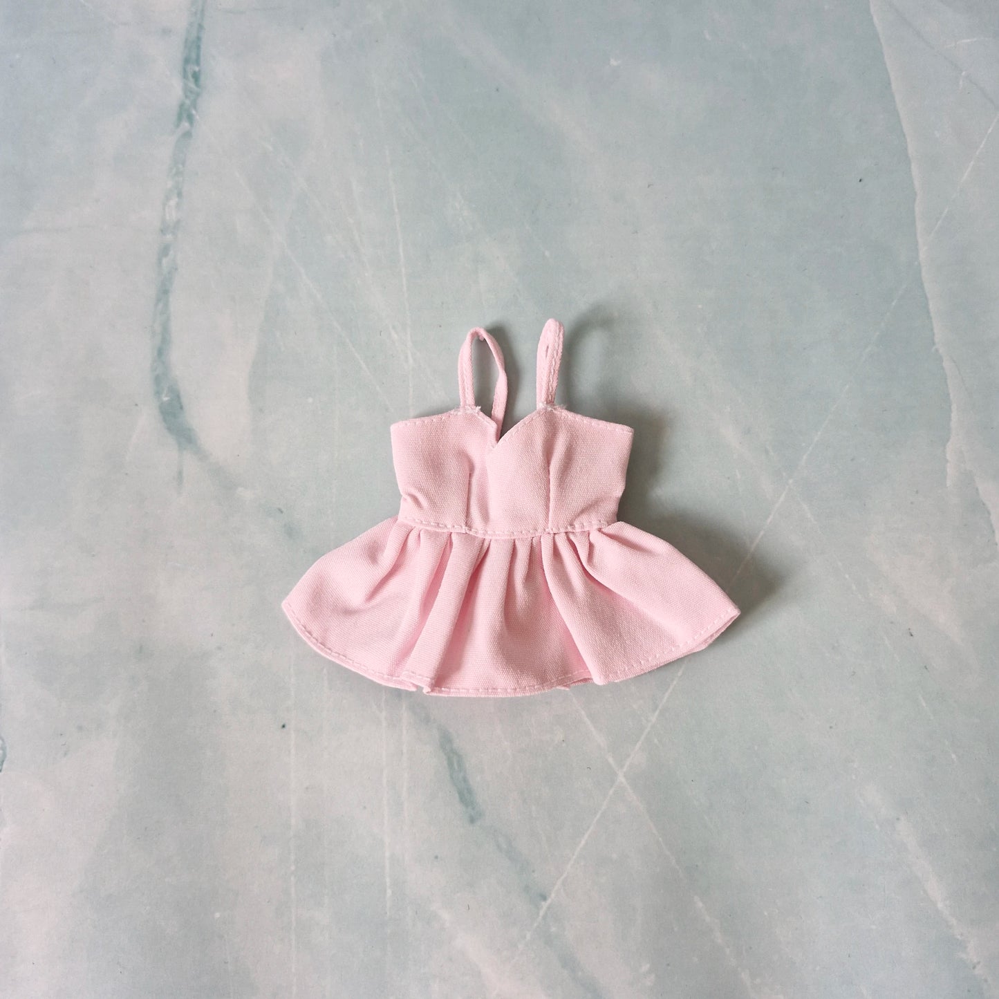 Pink dress on a marble surface