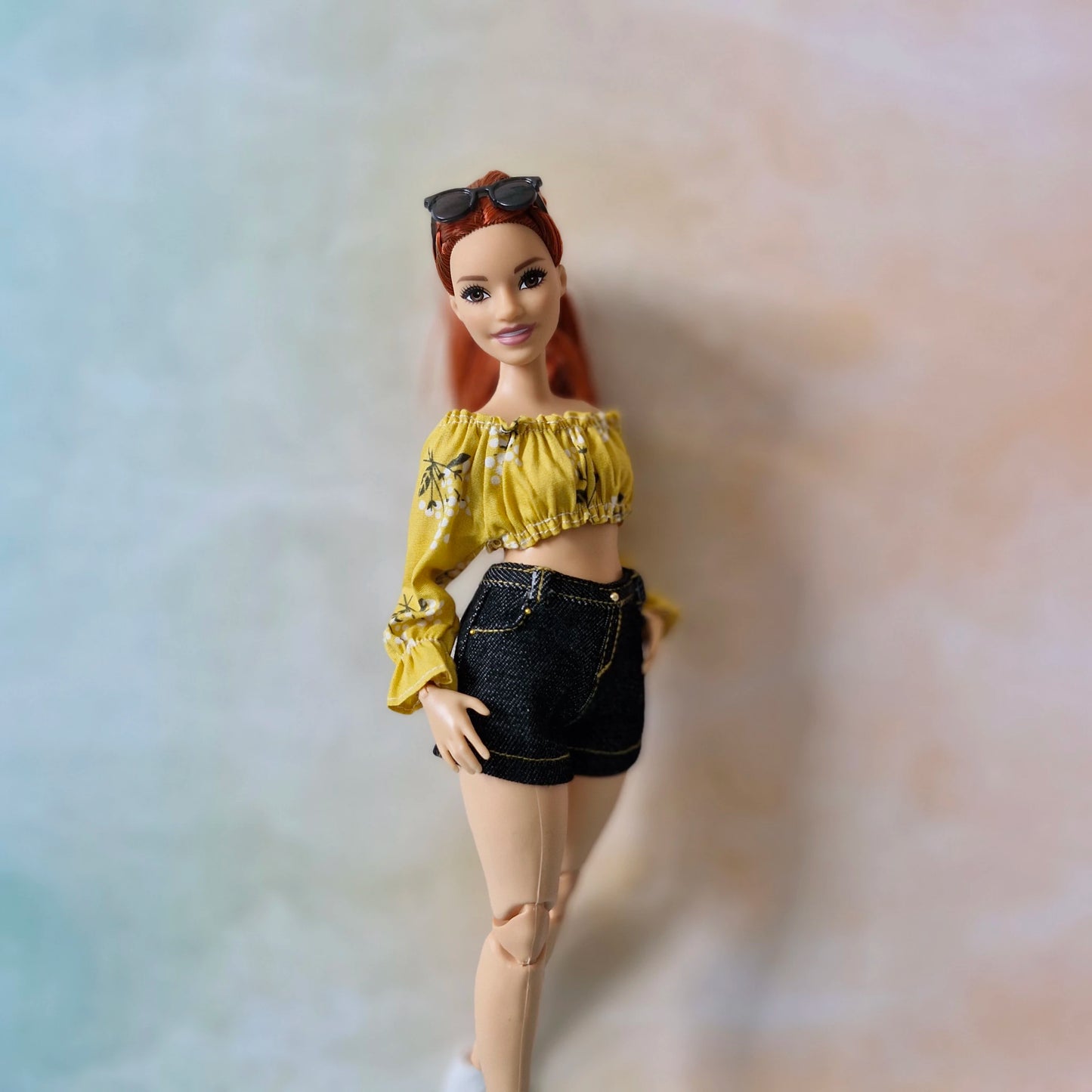 Close-up of the yellow floral off-the-shoulder top and shorts outfit for Curvy Barbie.