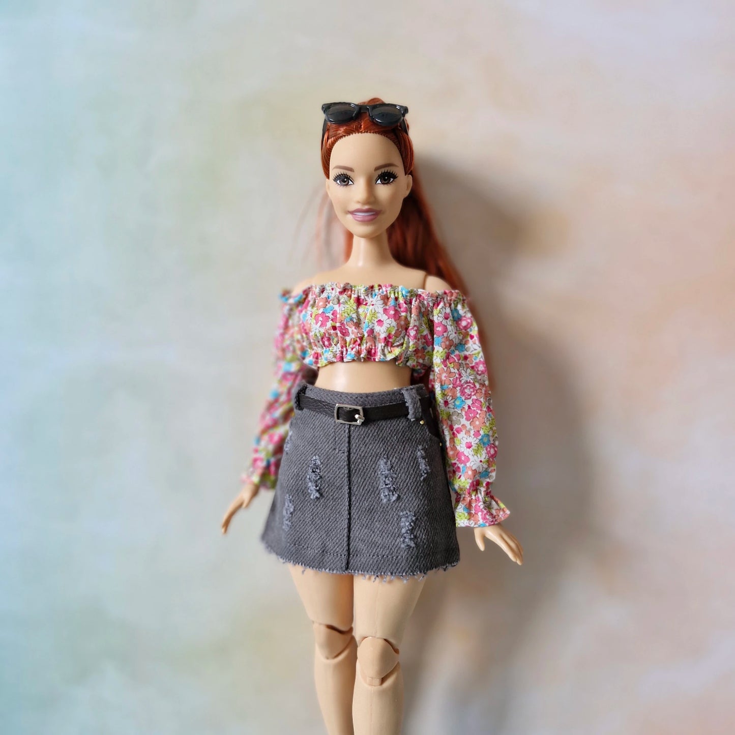 Front view of the handmade floral top and belted grey denim skirt for Curvy Barbie dolls.