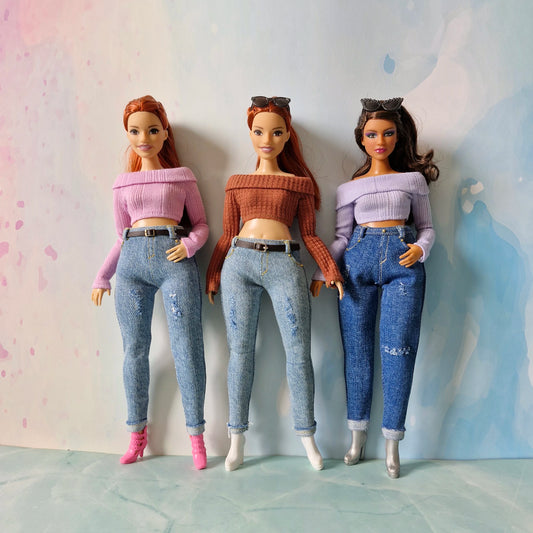 Three dolls with different hairstyles and outfits against a light background