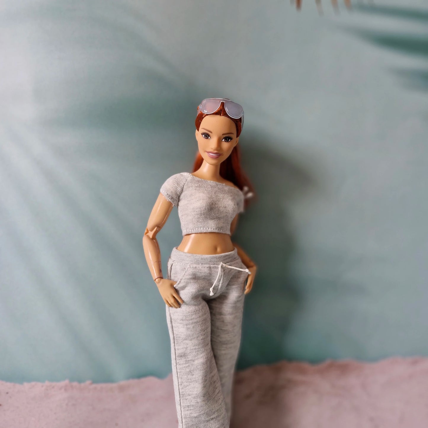 barbie doll wearing grey crop top and sweatpants close up