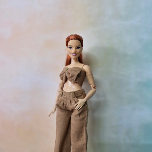 Barbie Curvy doll dressed in camel brown bow top and matching wide-leg pants.