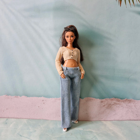 Full body shot of Curvy Barbie standing wearing light wash denim pants and crop top