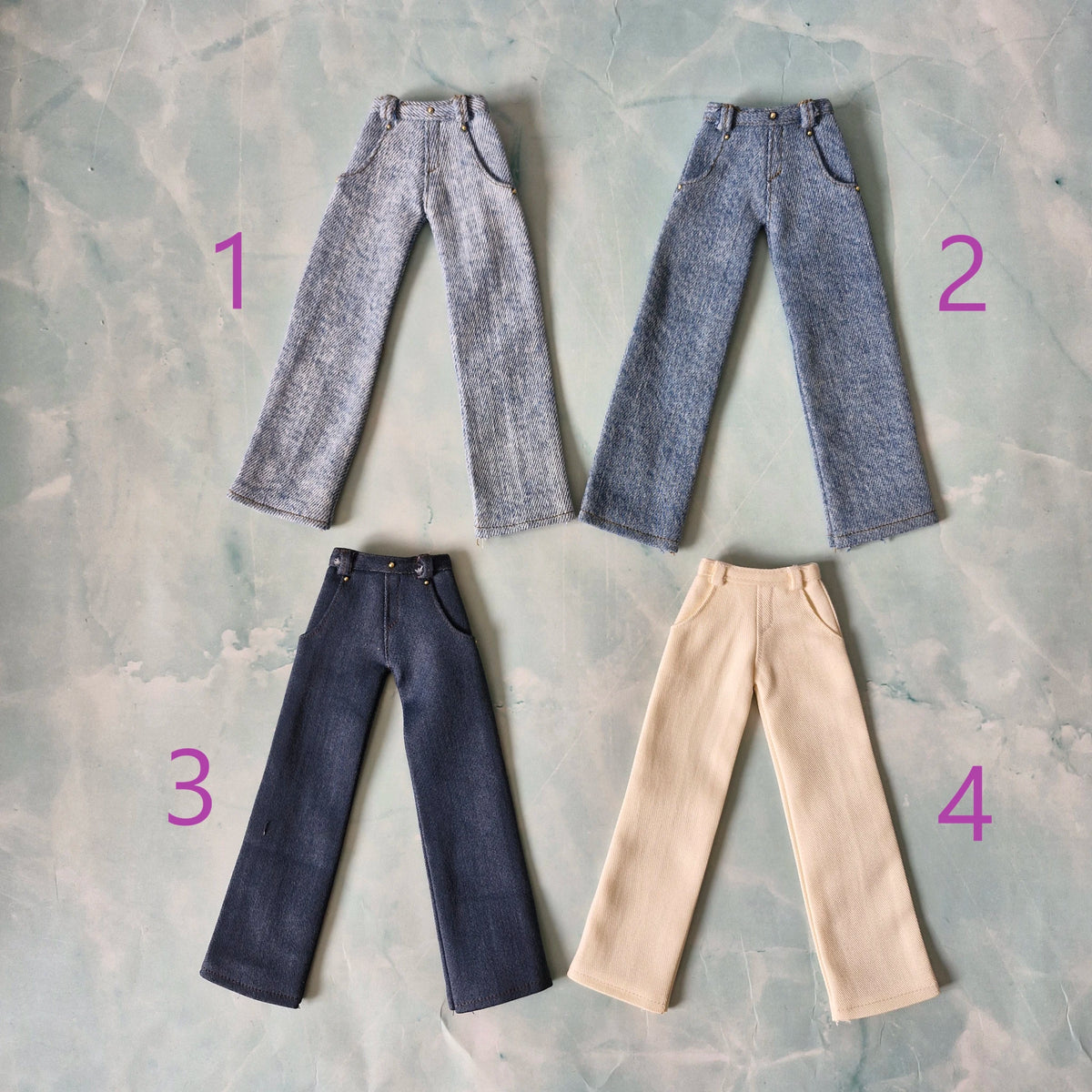 Flat lay of 4 pairs of handmade 1/6 scale trousers for Ken dolls, numbered 1 to 4.