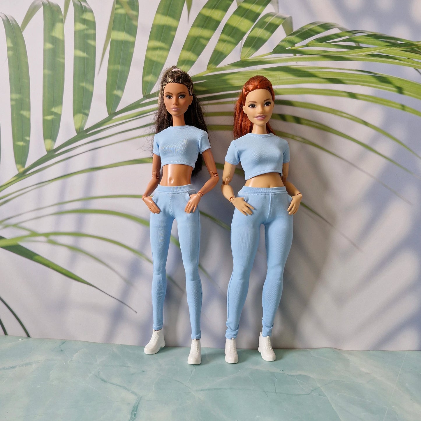 Two 11.5 inch dolls wearing matching light blue ribbed top and pants separates, tailored for Curvy and for Barbie.
