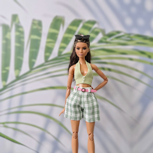 Brunette fashion doll wearing a green ribbed halter top and matching green plaid shorts for Barbie.