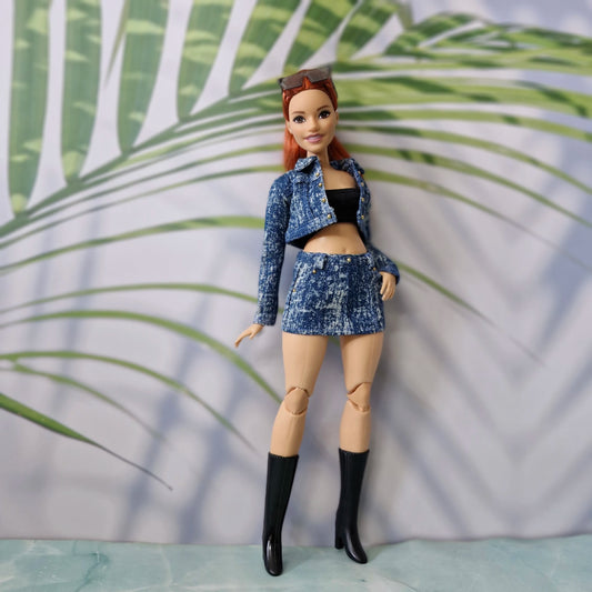 Full body view of a 1/6 scale Curvy fashion doll wearing a trendy medium blue acid wash denim outfit with a black tube top.