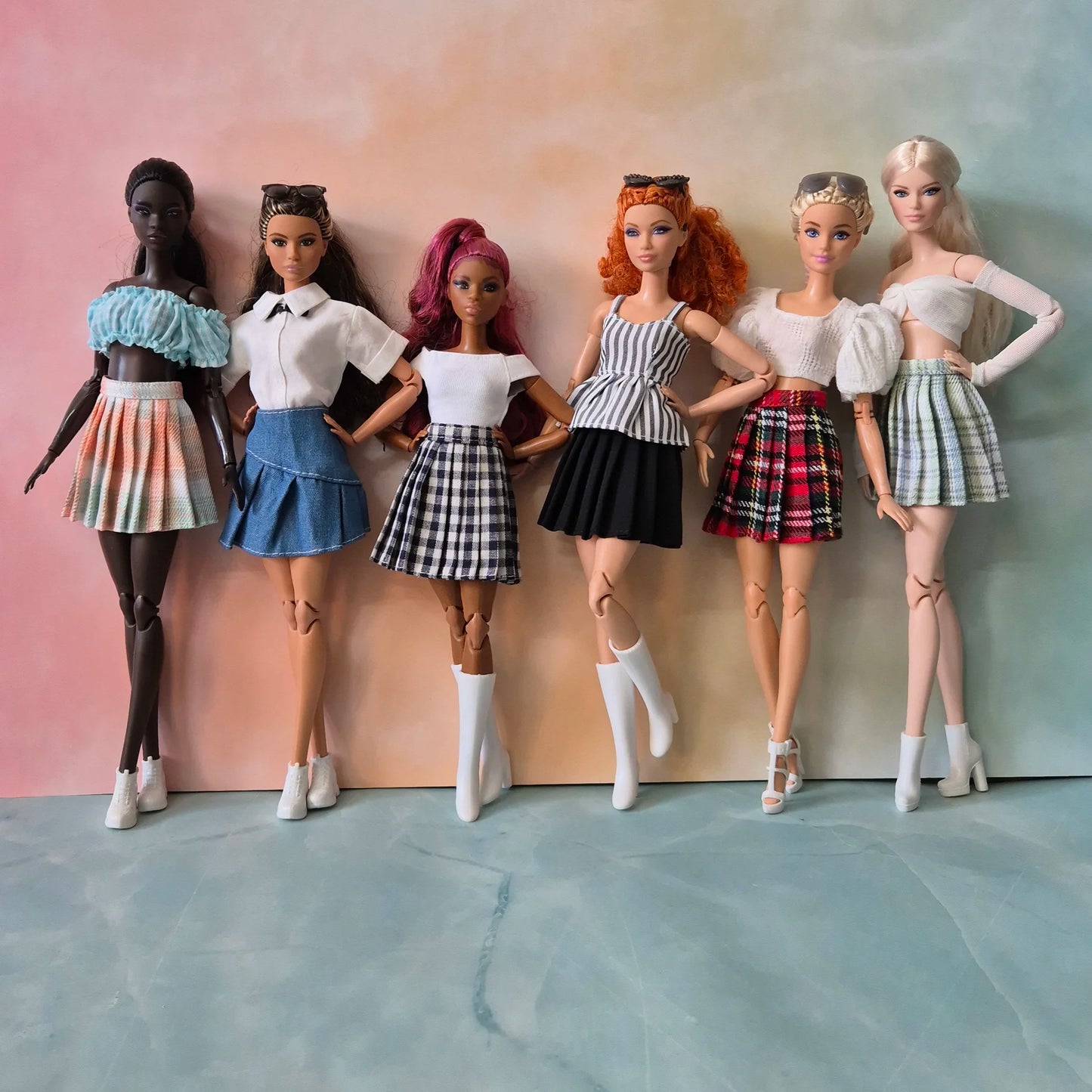 Barbie doll with red curly hair in striped peplum top, black skirt, and white boots.