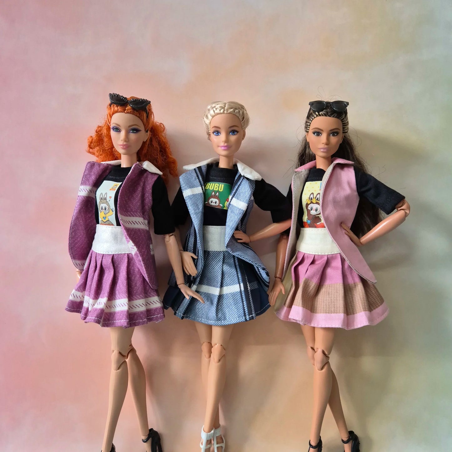 three barbie with sets