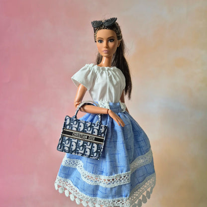 White top and blue skirt for barbie doll