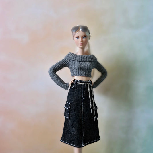 Fashion doll wearing grey off-shoulder crop top and black denim cargo midi skirt, posing with hands on hips.
