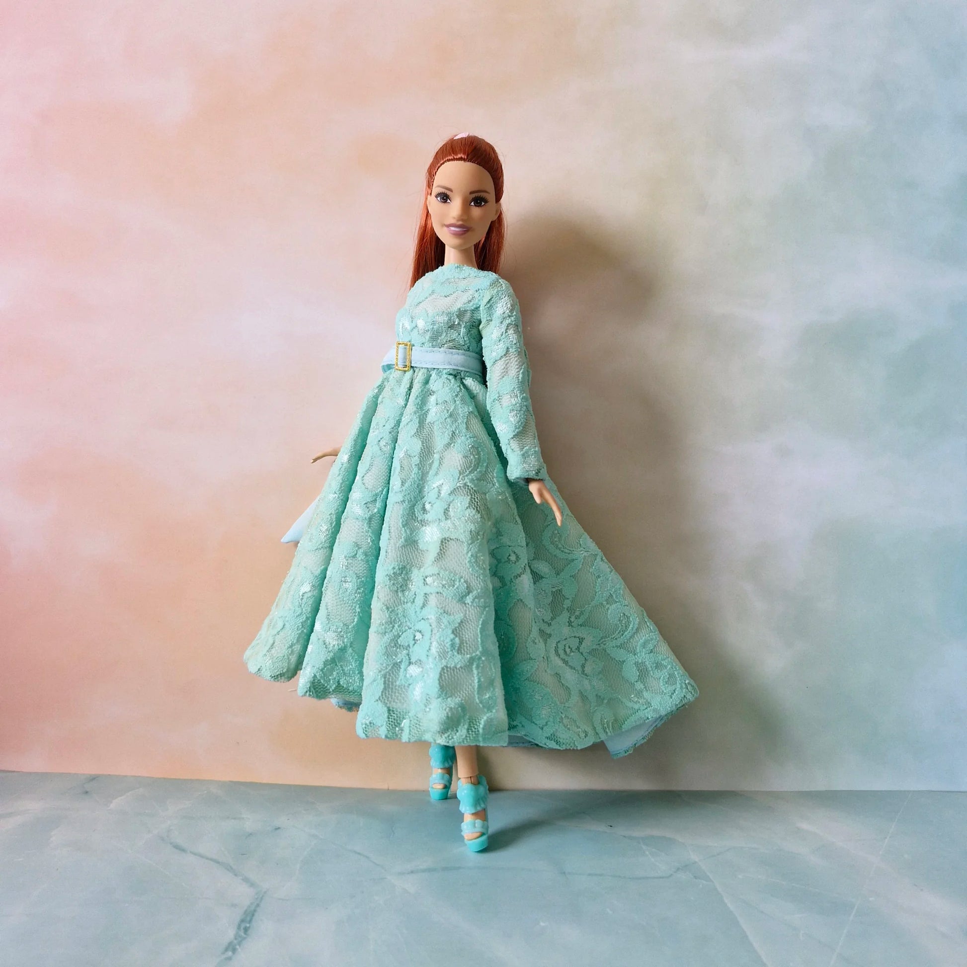 Barbie Curvy doll standing in sophisticated mint green lace dress showing the full skirt and high-low hemline.