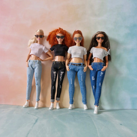 Four Barbie dolls side-by-side showcasing distressed skinny jeans in various colors with crop tops