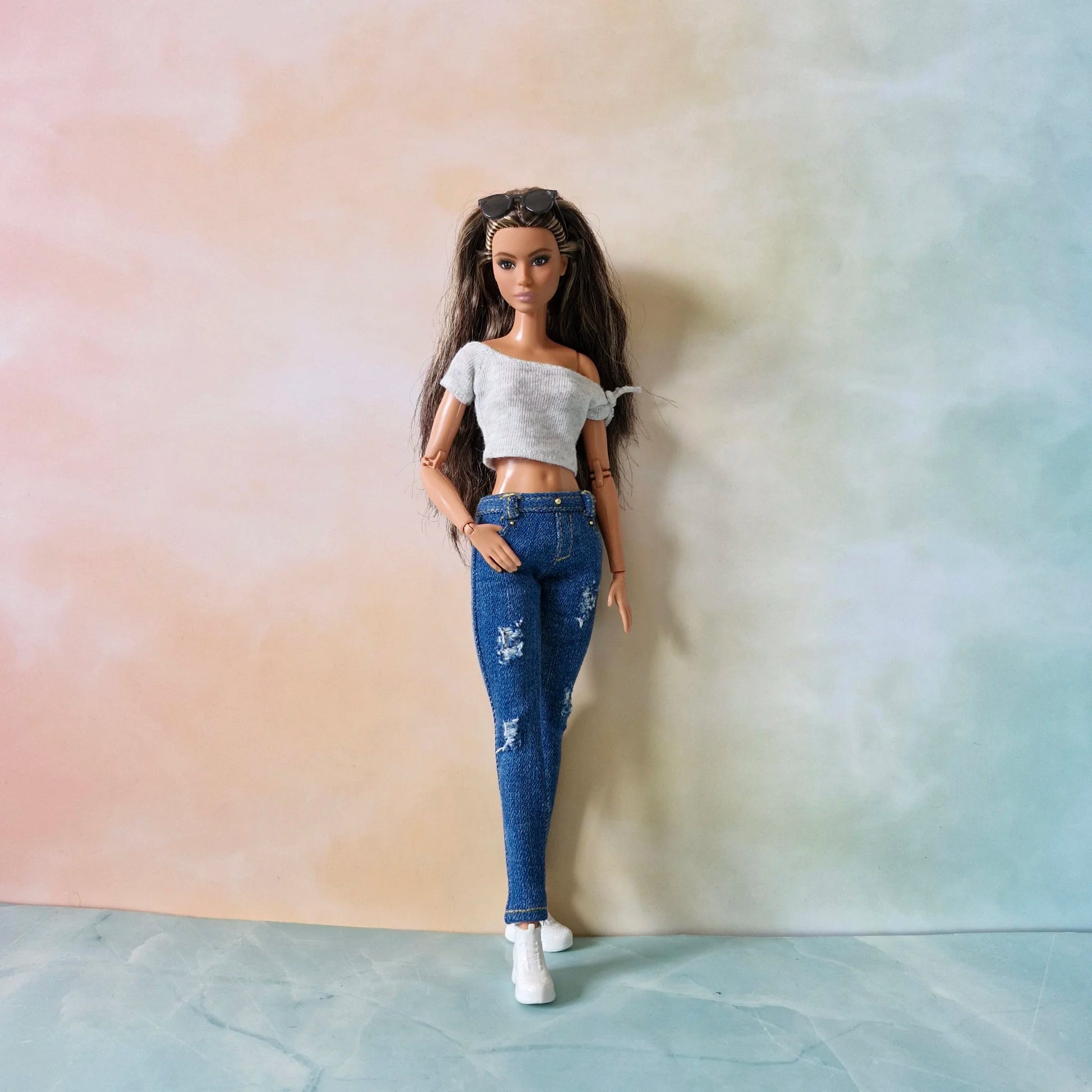 Full length brunette Barbie doll in white crop top and ripped blue skinny jeans with white shoes