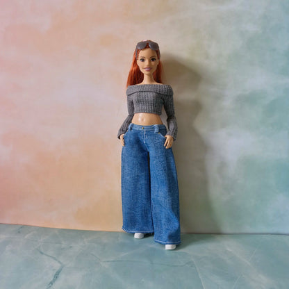 Full length redhead Curvy Barbie doll wearing grey crop top and wide-leg blue jeans