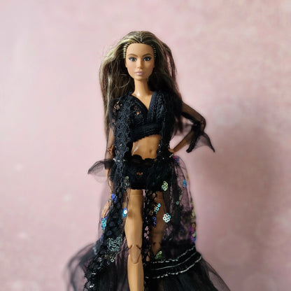 Close-up of brunette Barbie in black sheer sequin and lace robe from the 3-set doll collection.