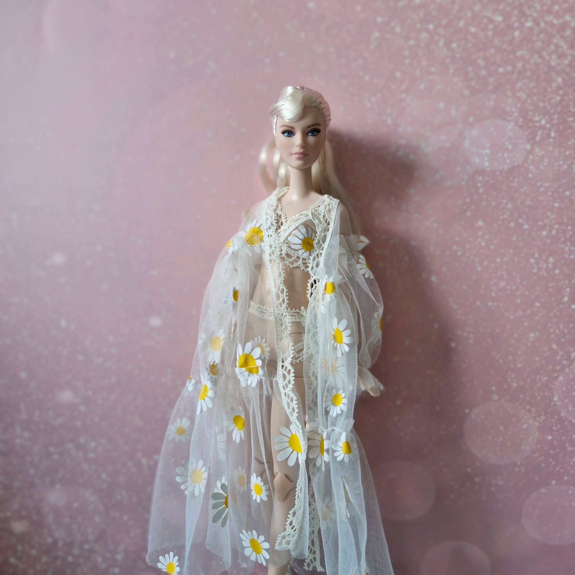 Close-up of platinum blonde Barbie in sheer daisy print robe, from the 3-piece doll lingerie set.