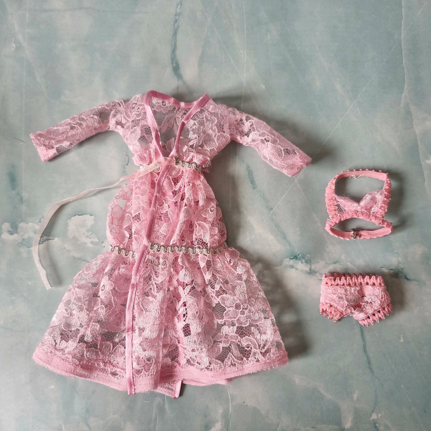 Details of pink lace Barbie doll robe, bralette, and panties from the 3-set collection.