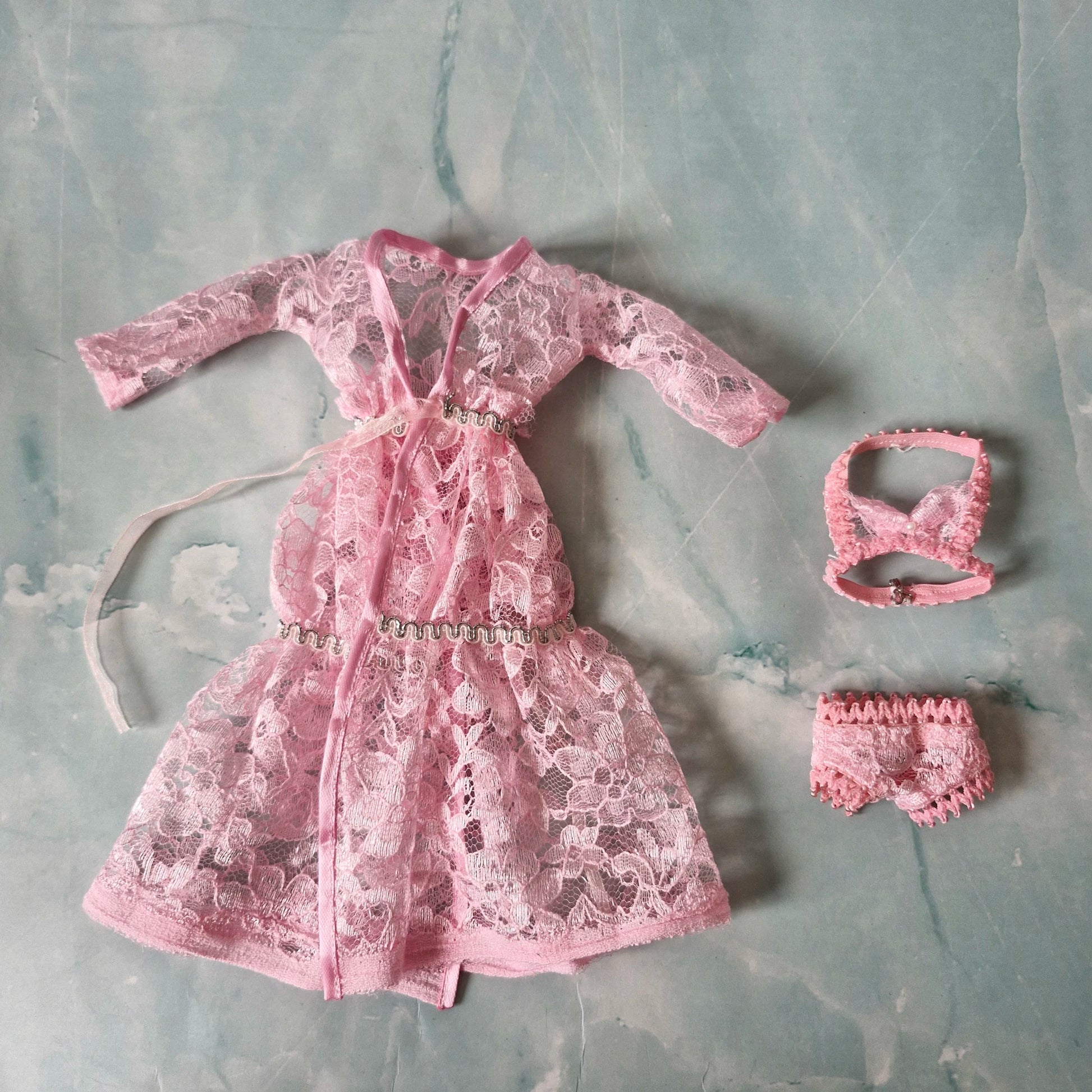 Details of pink lace Barbie doll robe, bralette, and panties from the 3-set collection.