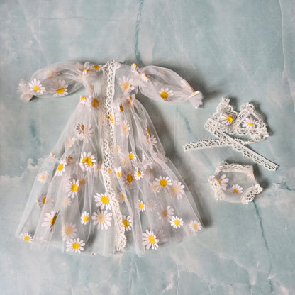 Flat lay of white sheer daisy print Barbie doll robe and lingerie set from collection.