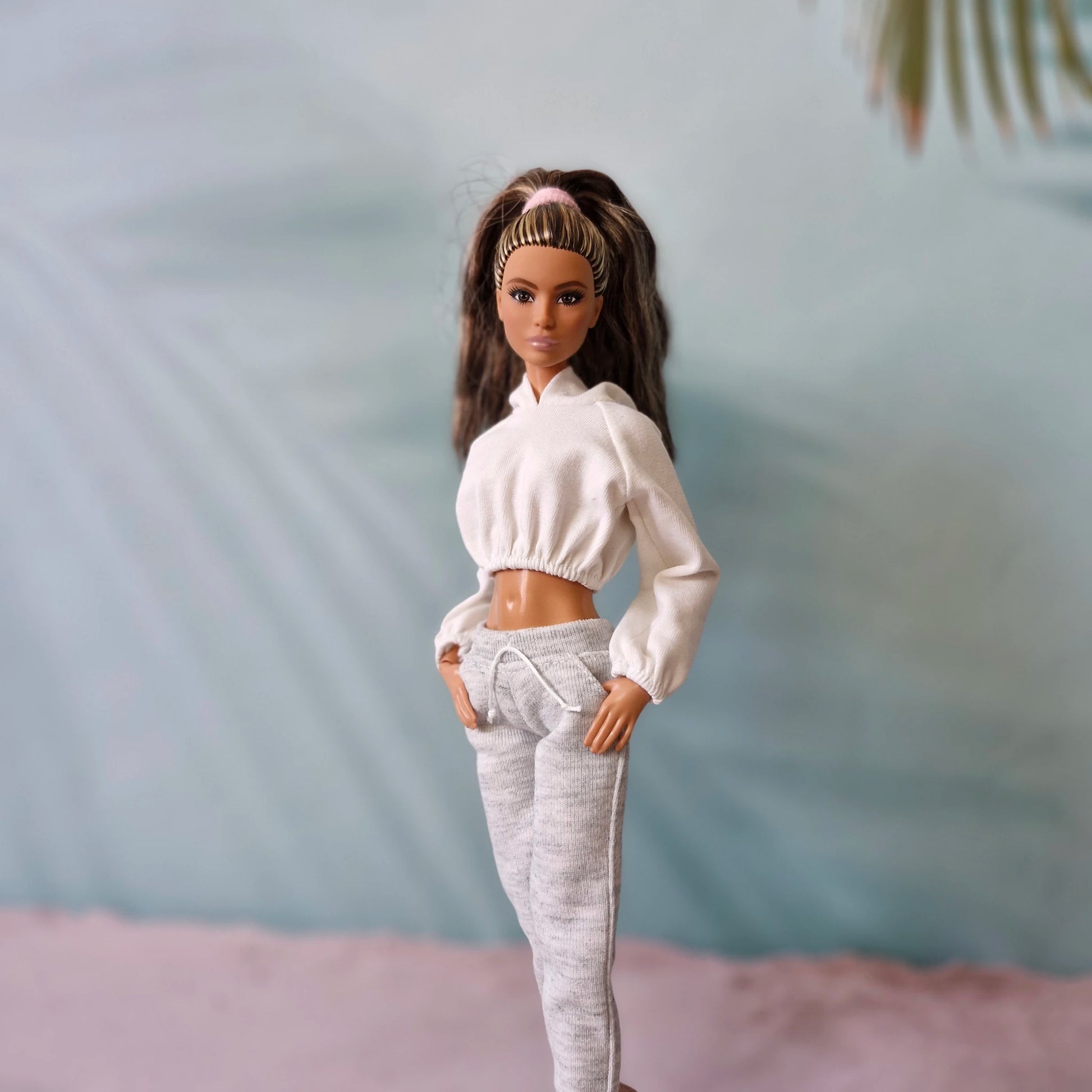 Barbie doll wearing white cropped hoodie and grey sweatpants casual athleisure set.