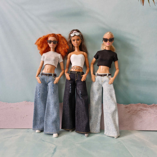 Group photo of three Barbie dolls showcasing Y2K street style with wide-leg jeans and crop tops.
