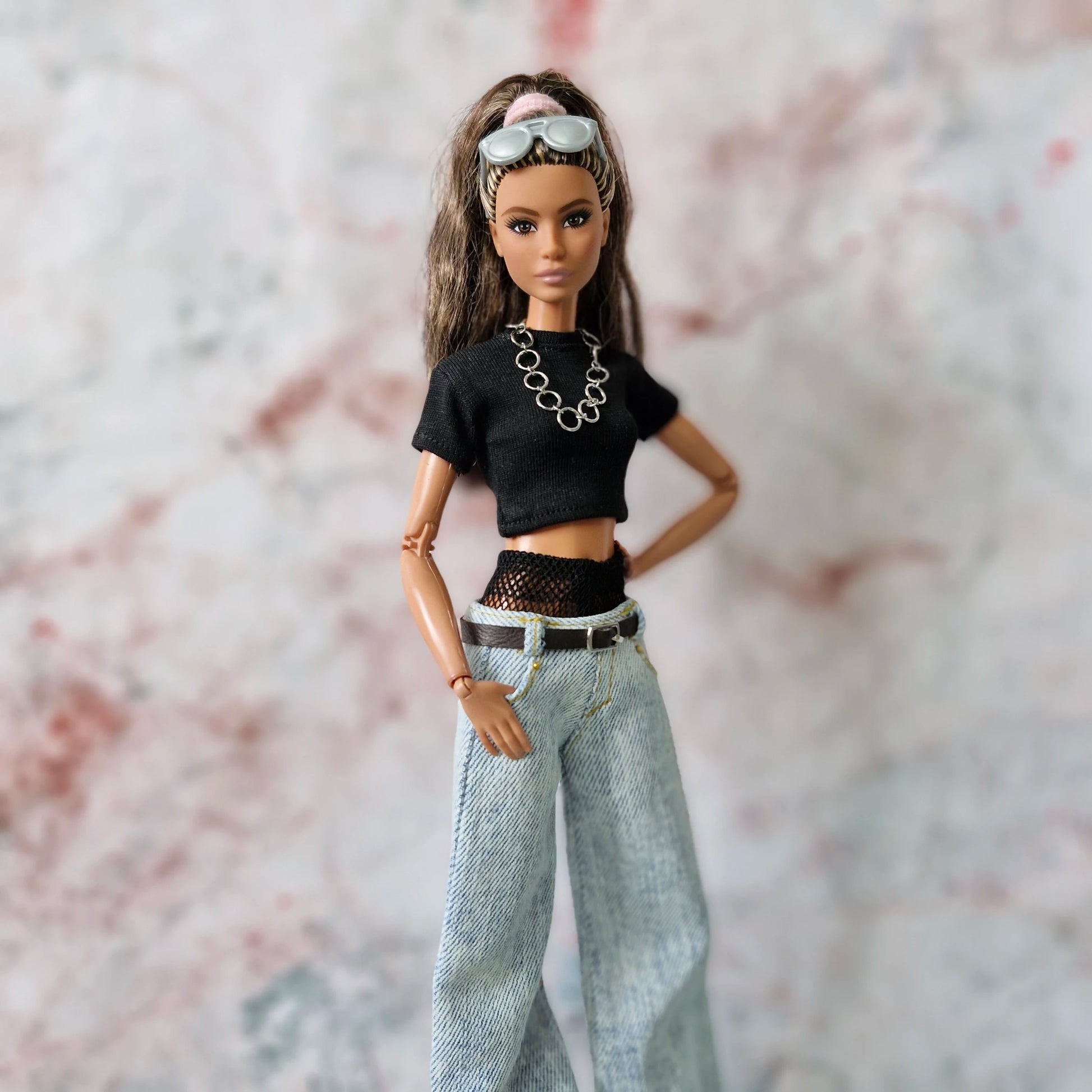 Shop Y2K Barbie clothes! This set includes a layered crop top and wide-leg jeans for the ultimate doll street-style look.