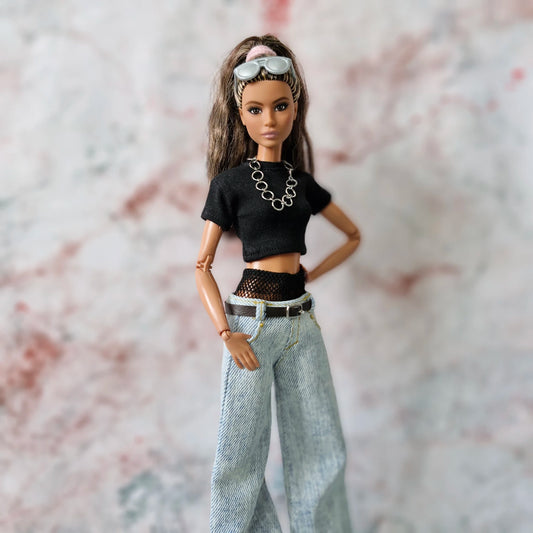 Shop Y2K Barbie clothes! This set includes a layered crop top and wide-leg jeans for the ultimate doll street-style look.