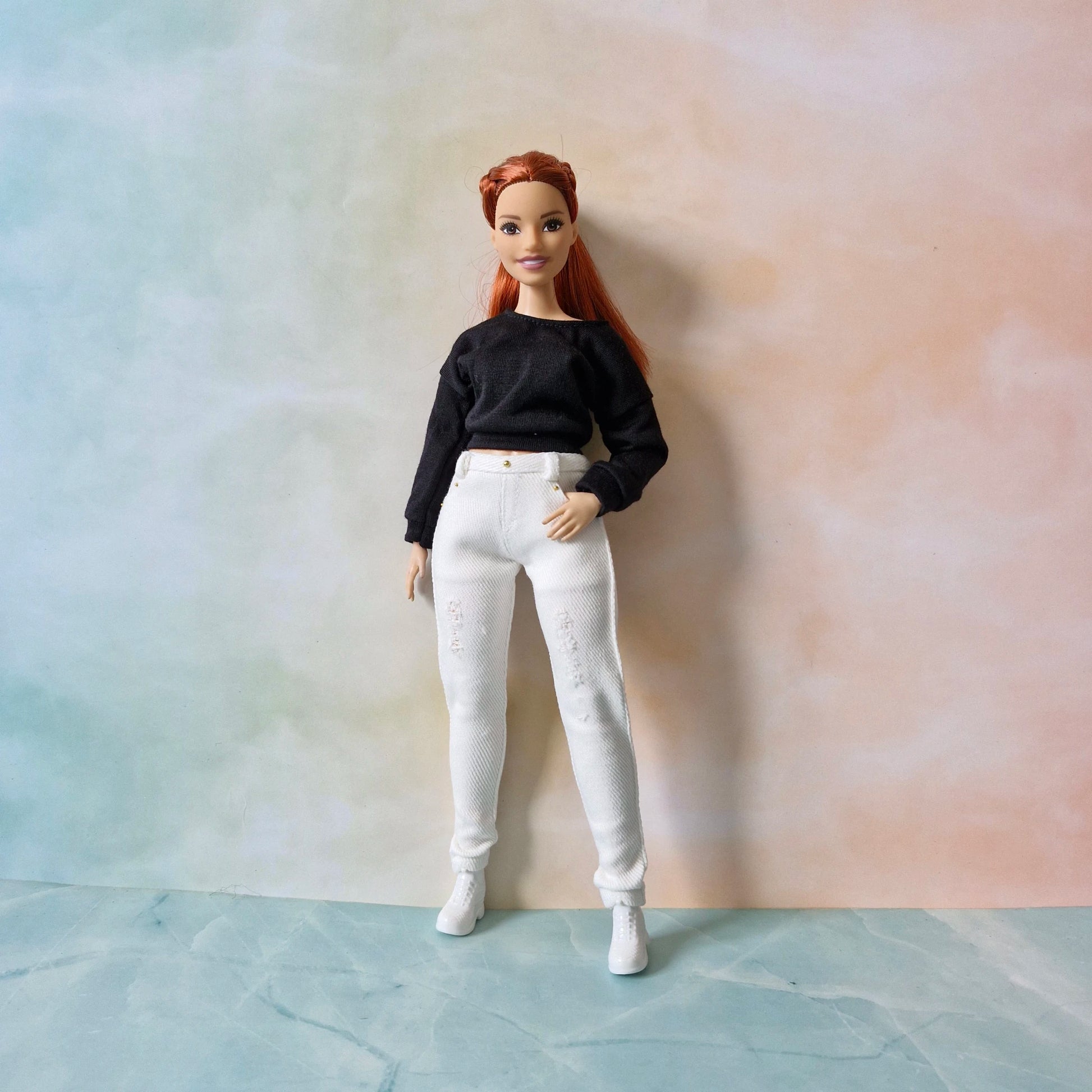 Curvy Barbie doll in a modern black top and white distressed denim pants