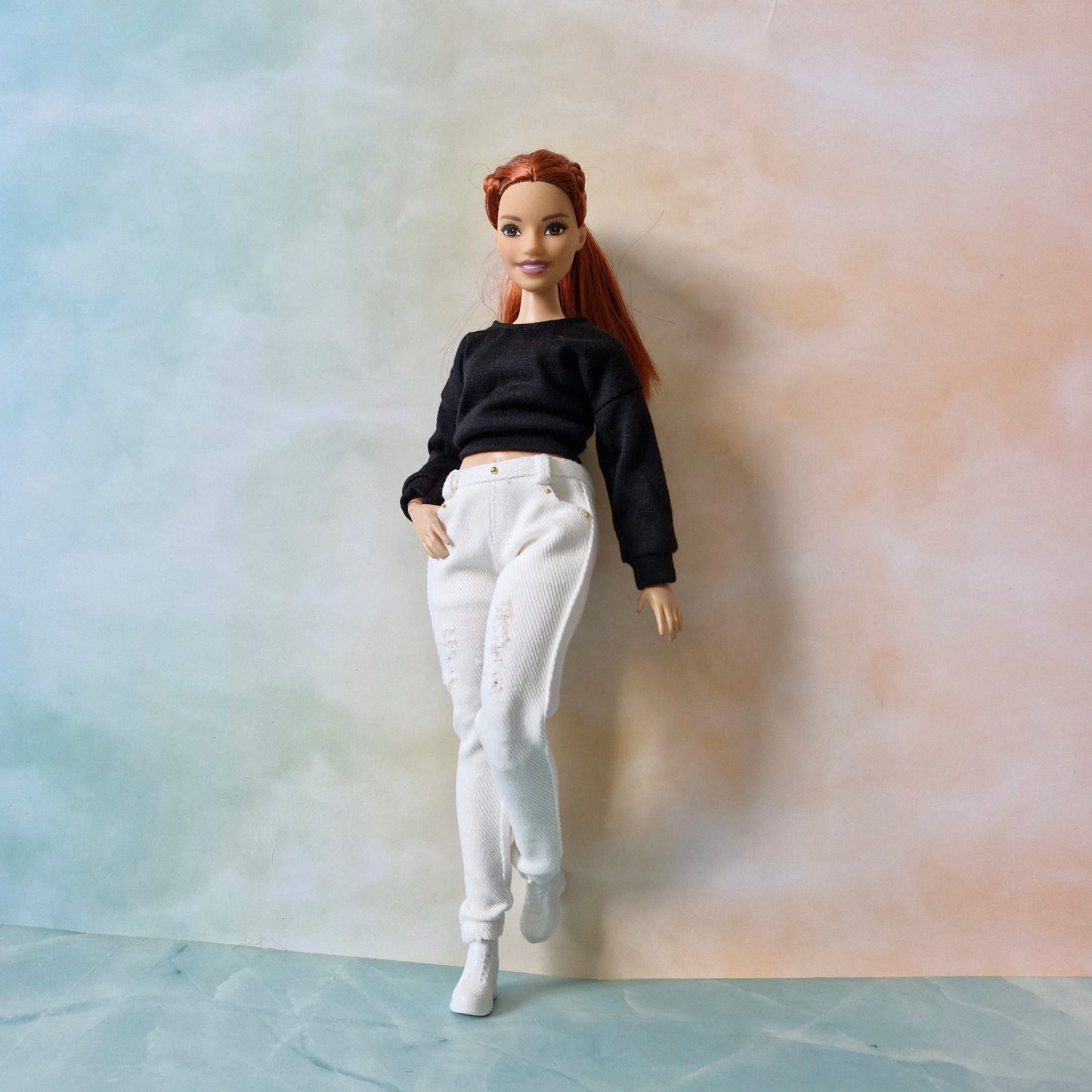 Curvy Barbie doll in white t-shirt and light blue acid wash jeans
