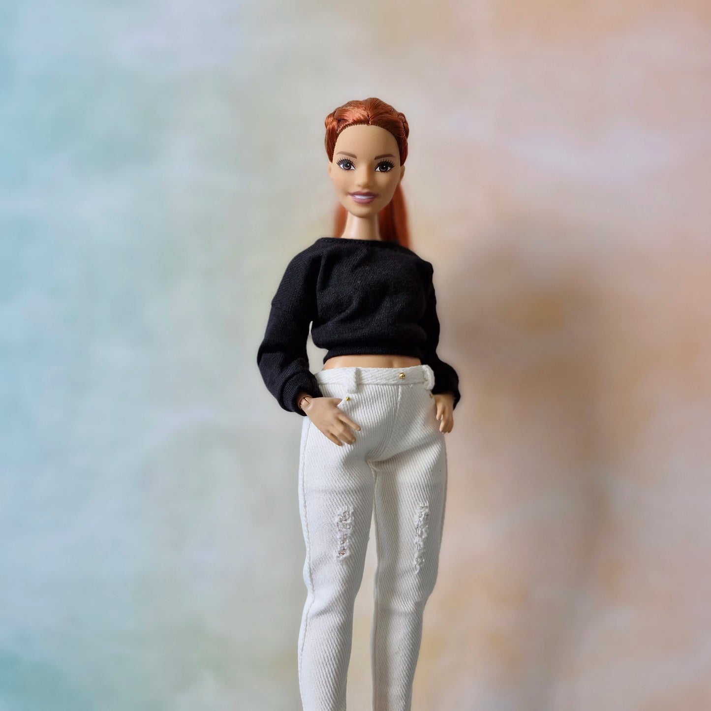 Curvy Barbie fashion doll wearing casual white top and stylish blue jeans
