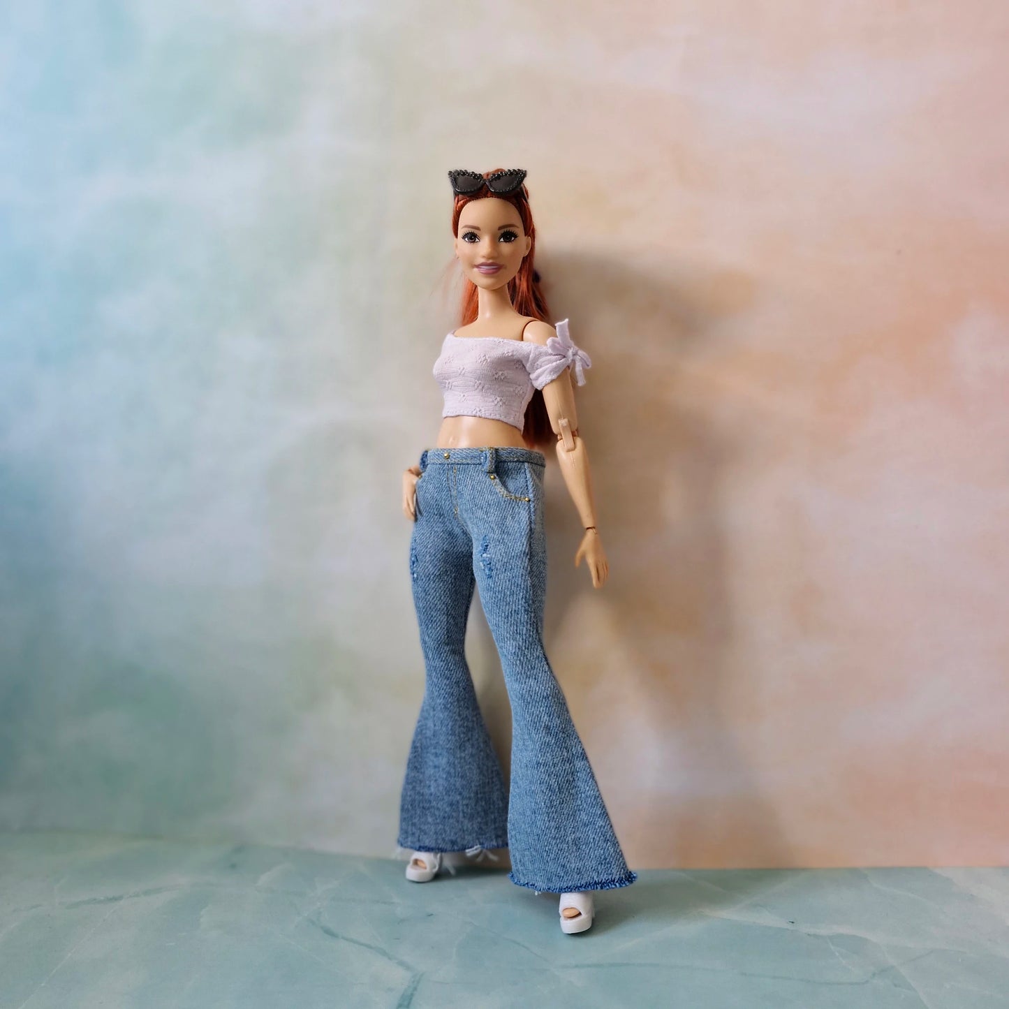 Full body of Curvy Barbie in blue jeans and white off-shoulder top