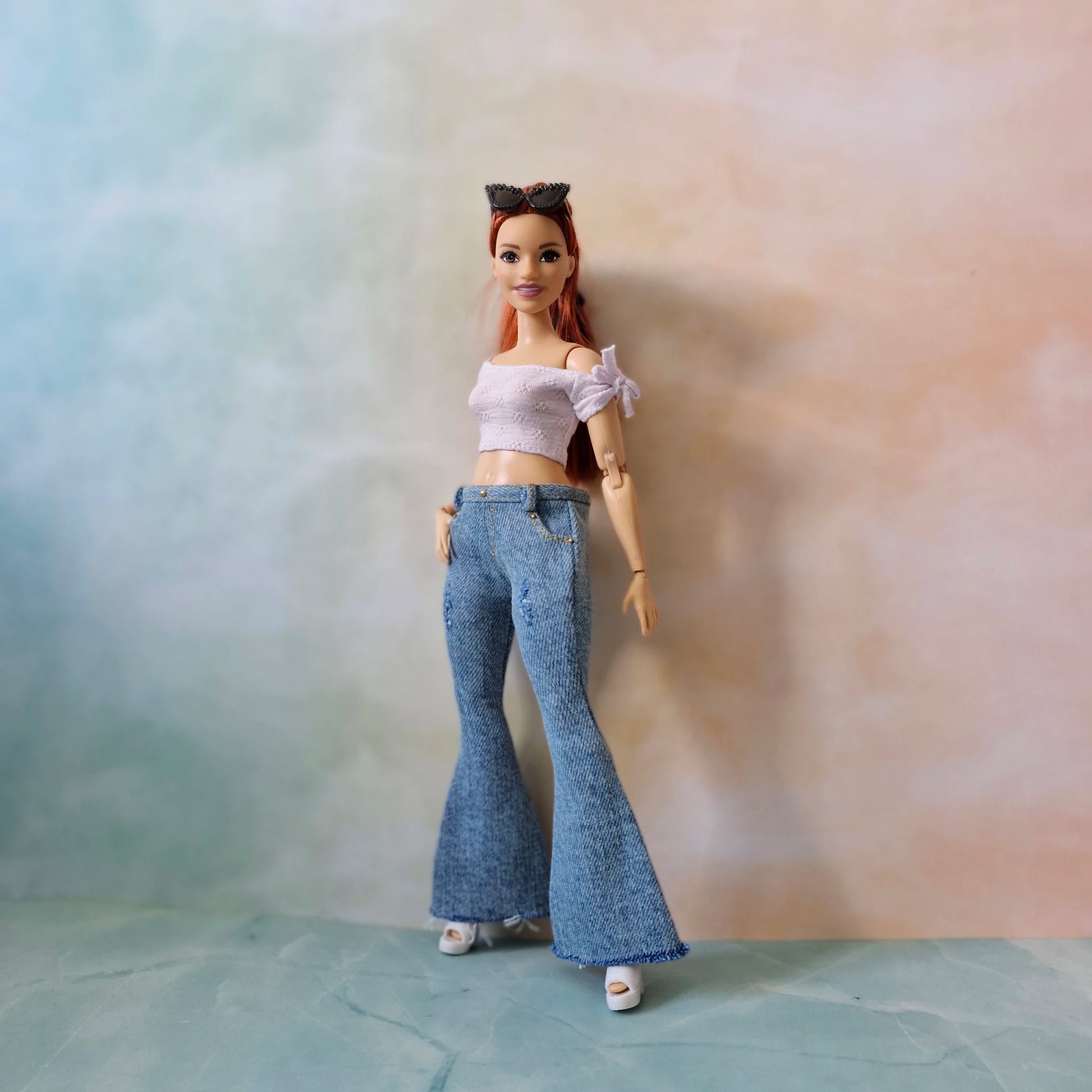 Full body of Curvy Barbie in blue jeans and white off-shoulder top