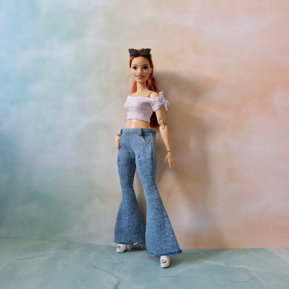 Full body of Curvy Barbie in blue jeans and white off-shoulder top