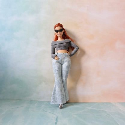 Curvy Barbie doll standing in gray knit top and light washed jeans