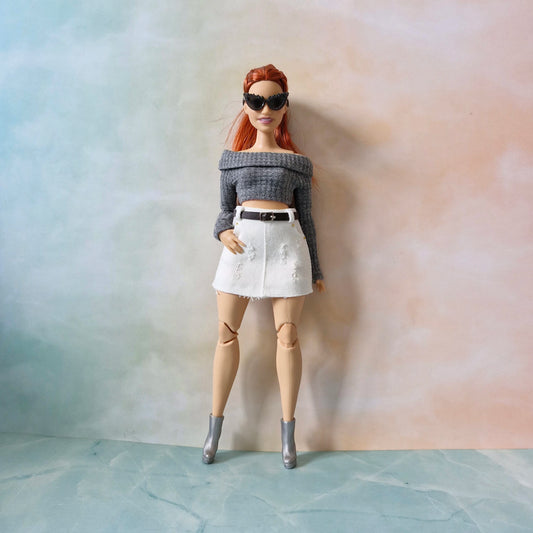 Barbie curvy wearing gray knit top and white skirt with heels
