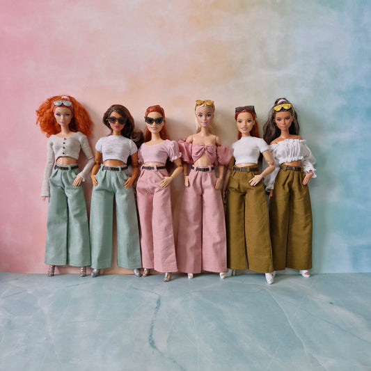 Six dolls in different outfits standing against a gradient background