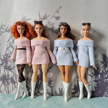 Four dolls wearing stylish outfits against a neutral background
