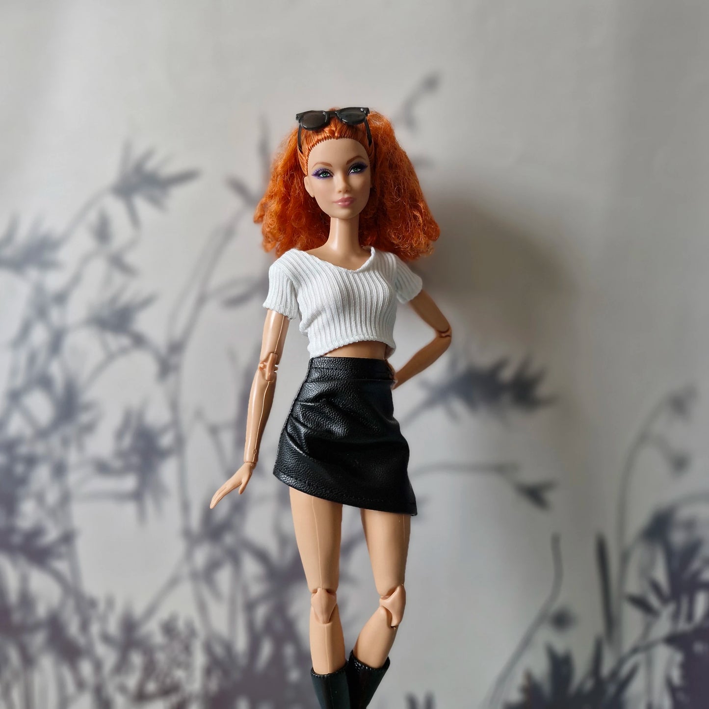 Barbie outfit featuring white crop top paired with black leather skirt

