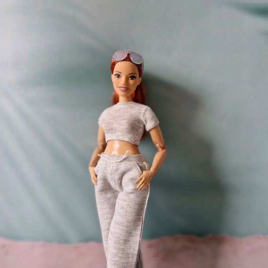 barbie doll wearing grey crop top and sweatpants close up
