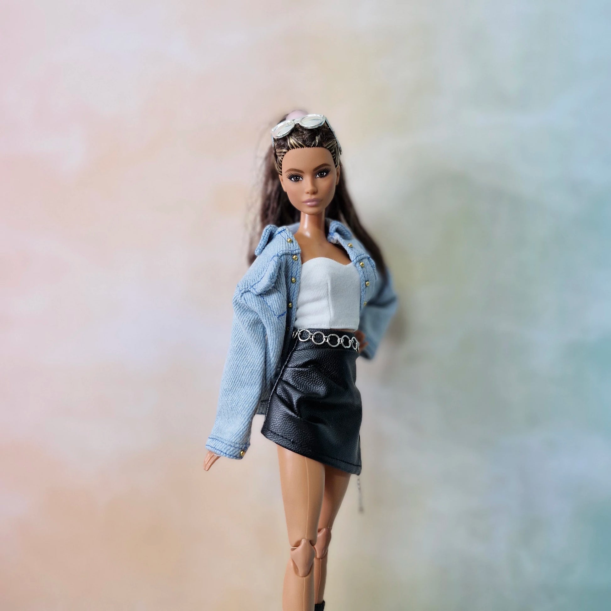 Barbie doll in denim jacket, white top and black leather skirt outfit
