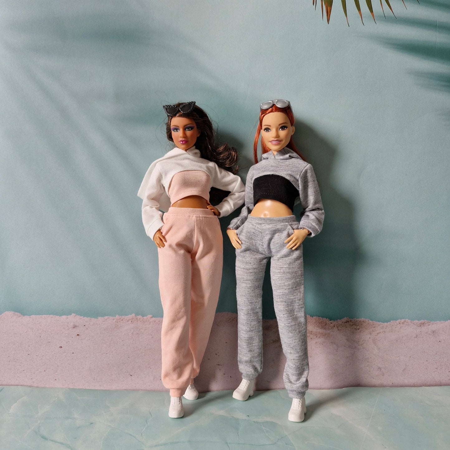 Two fashion dolls posing together wearing pink and grey casual athletic doll clothes