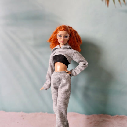 Redhead Barbie doll standing wearing grey cropped hoodie and joggers streetwear set